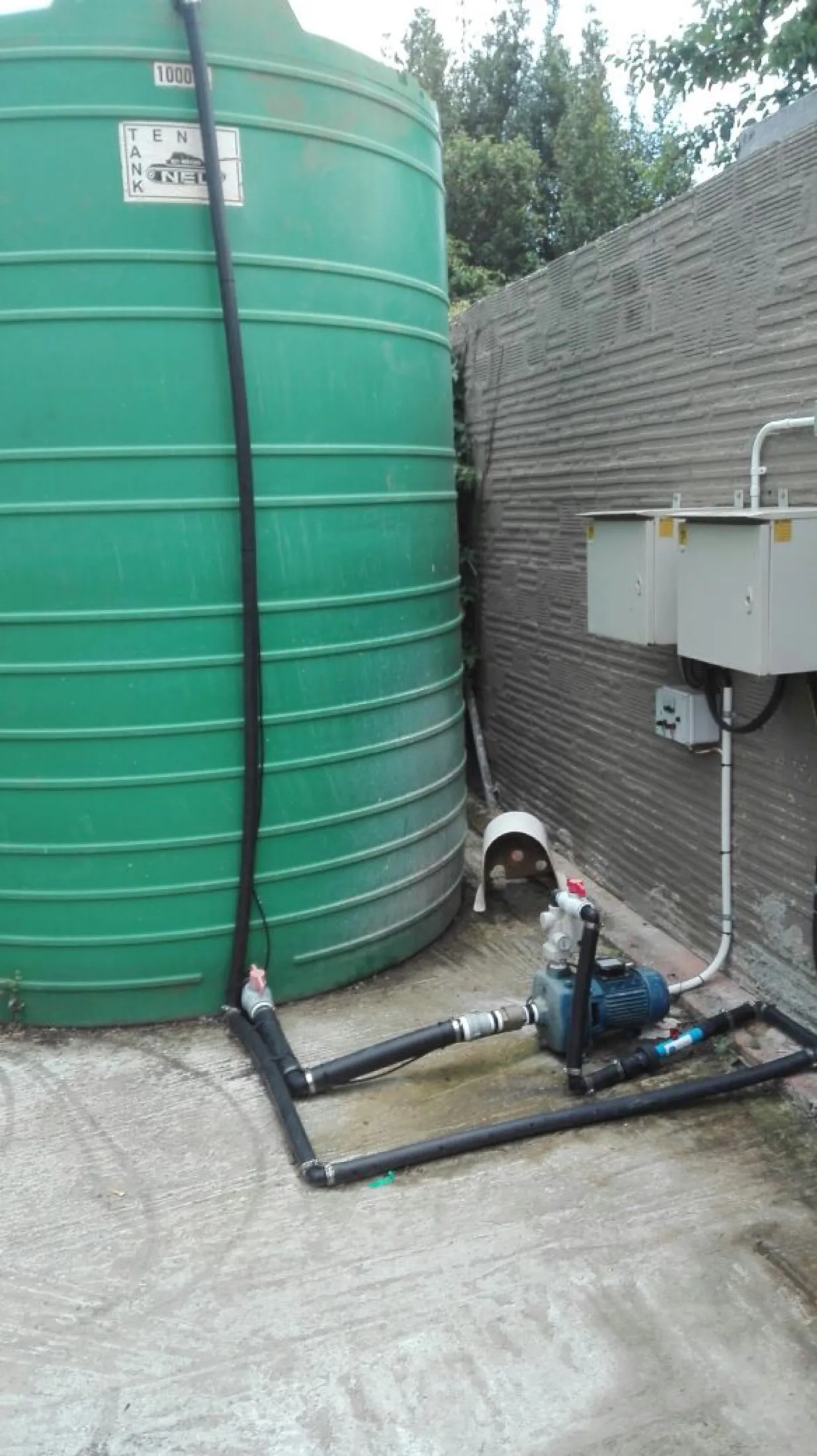 Green water storage tank with pump and control box installed
