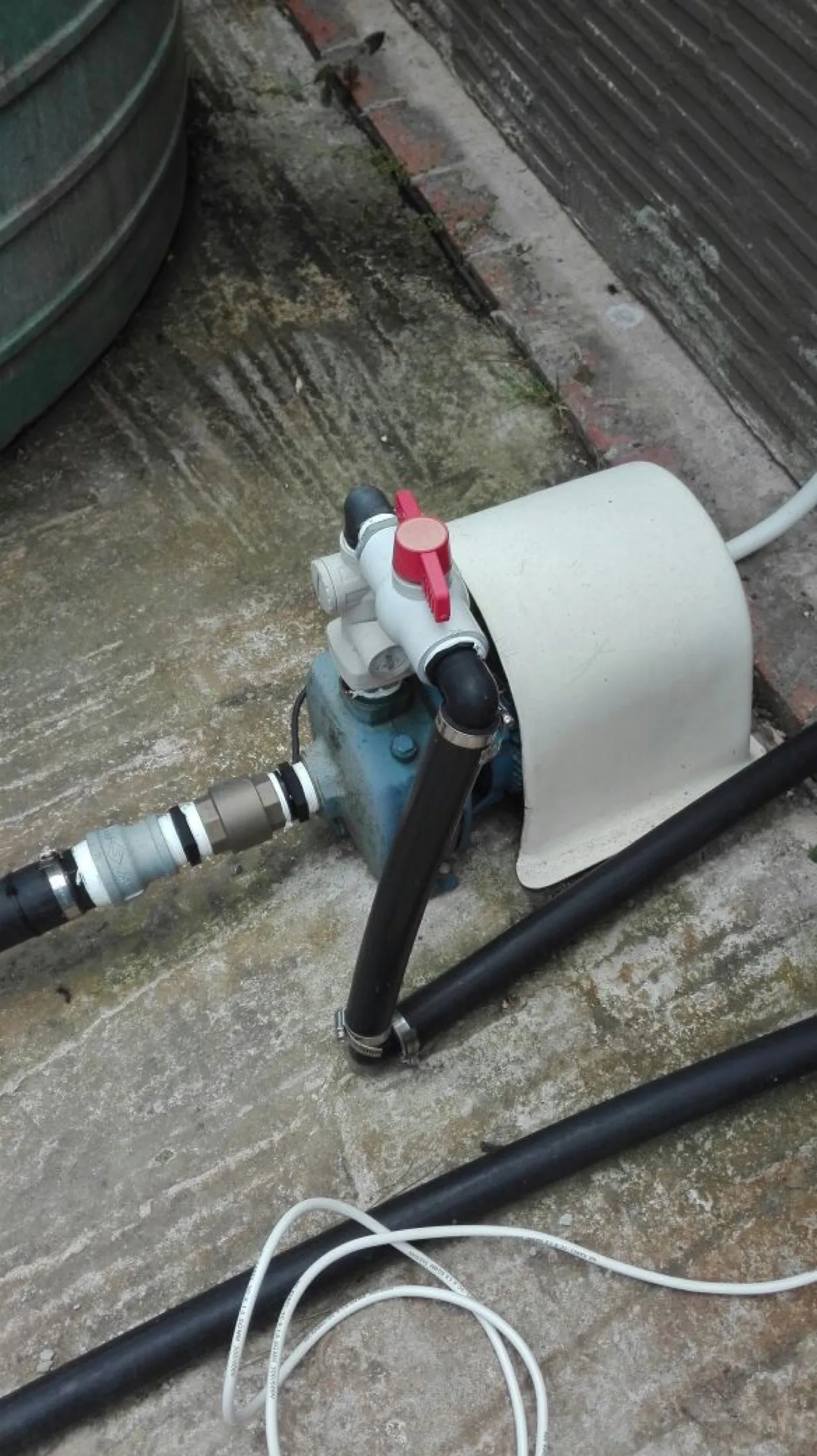Inline pump and conditioner unit installed on black poly pipe
