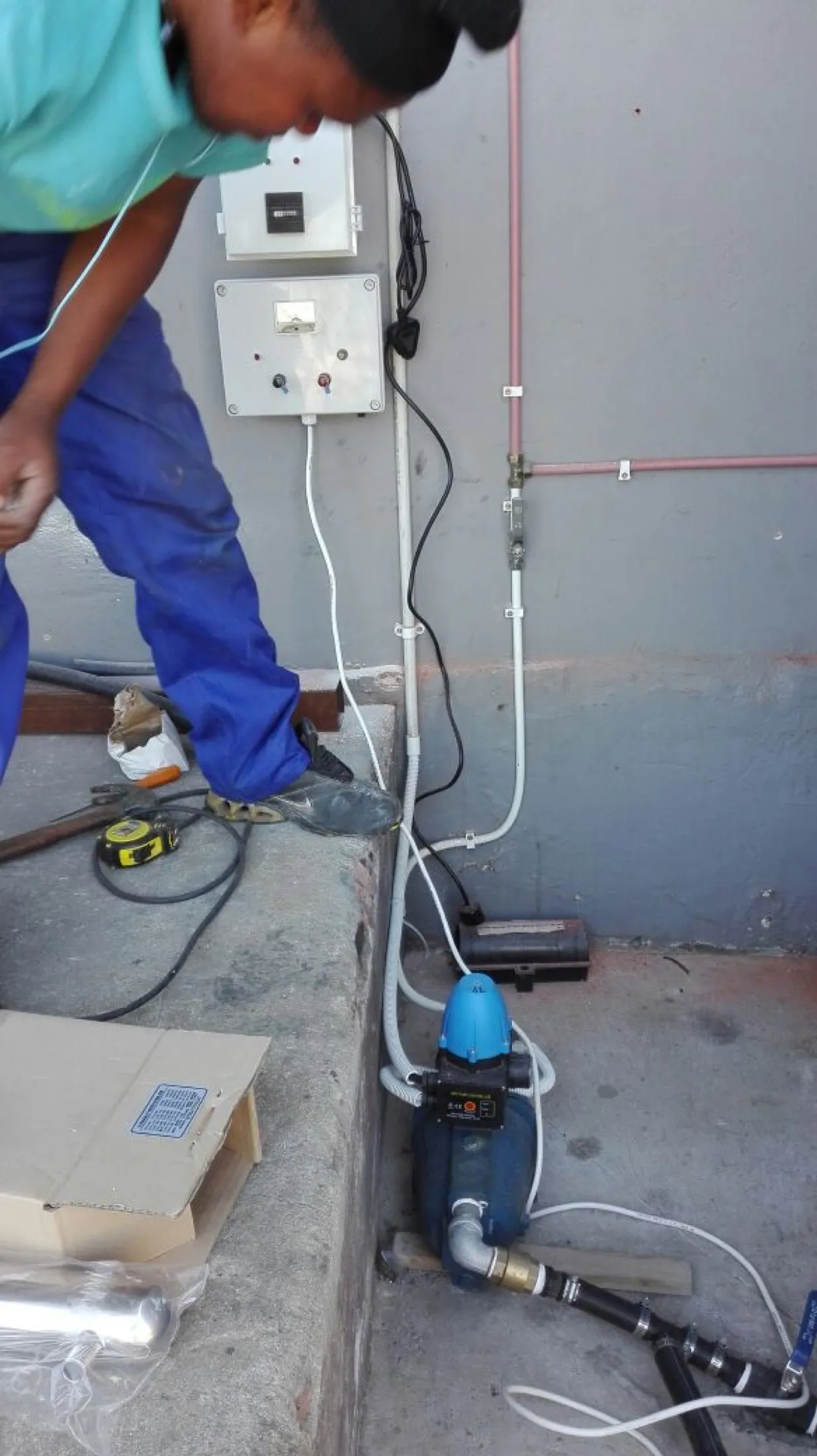 A technician wiring the electron booster control box on site