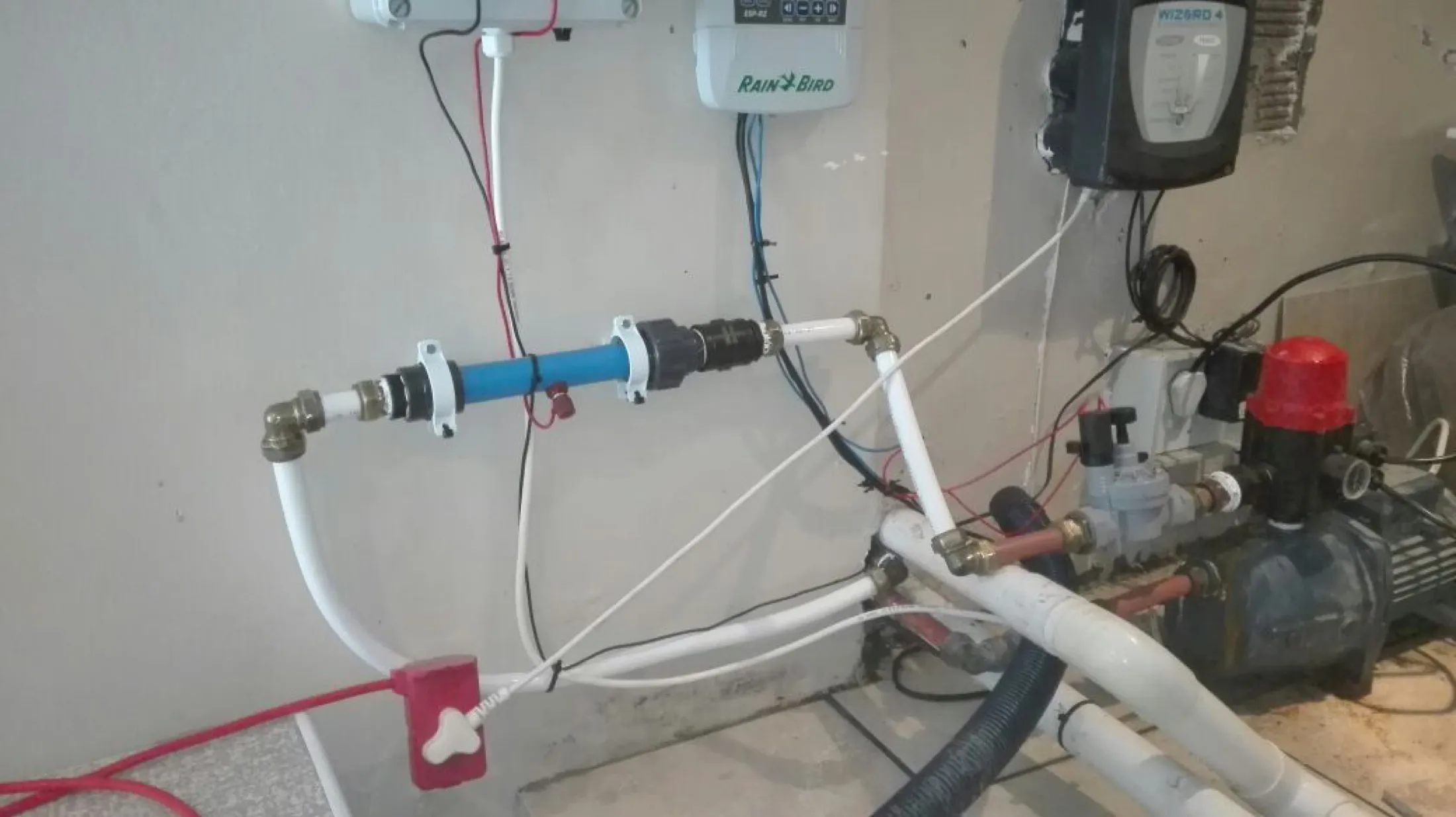 Close view of the inline unit and its cabling on a wall